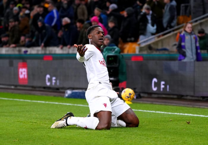 Kobbie Mainoo pictured celebrating after scoring the first goal of his Premier League career to seal a 4-3 win for Manchester United at Wolves in February 2024